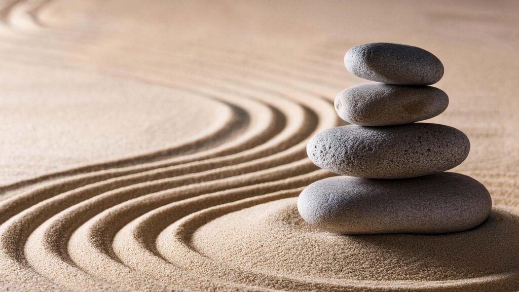 Japanese zen garden with stacked stones and raked sand