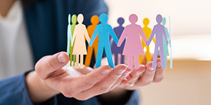 Community concept with a bunch of different people cut out of paper