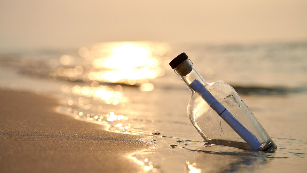Message in a bottle swept up on beach.