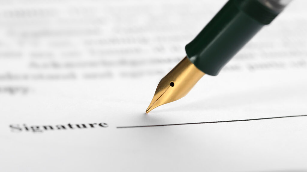 Pen writing out signature.